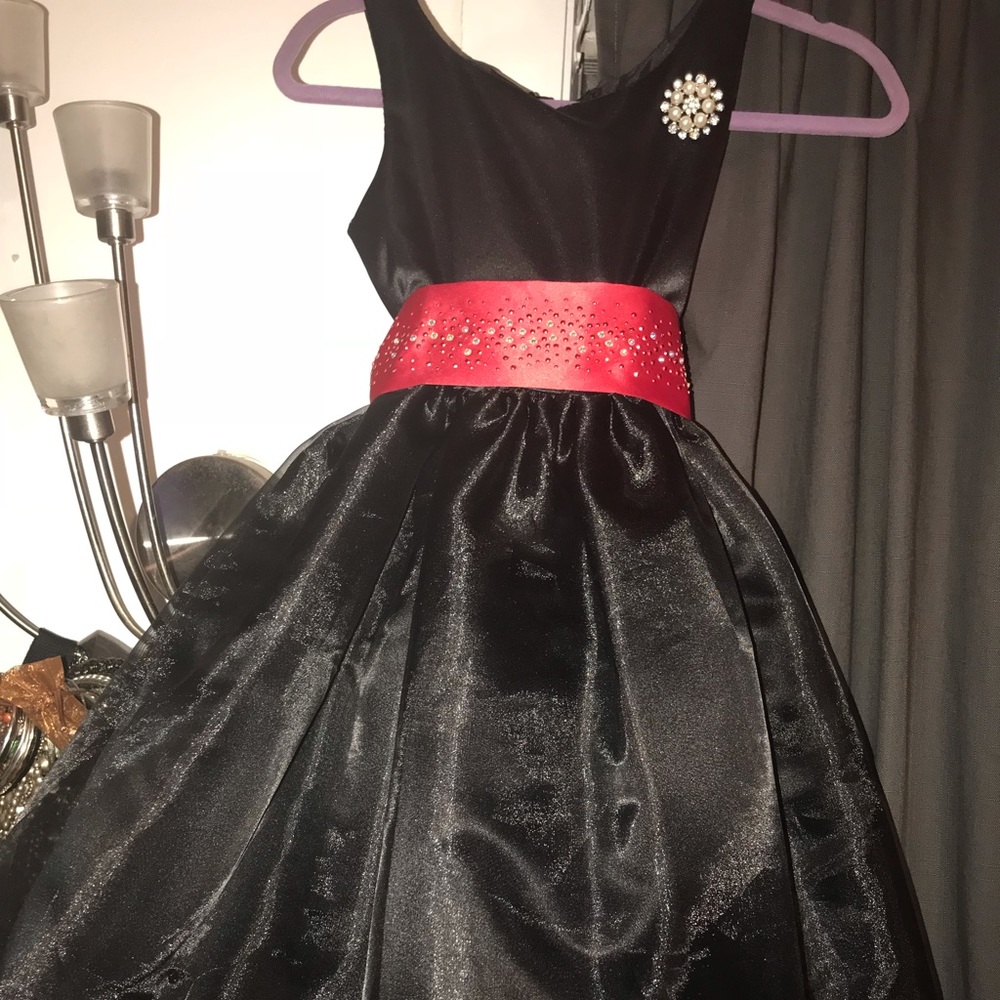 Black holiday dress with red bedazzled ribbon